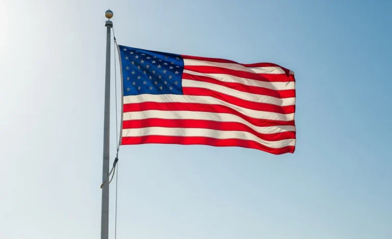 An American flag flying at half-staff against a clear blue sky, illustrating why are flags at half mast today.