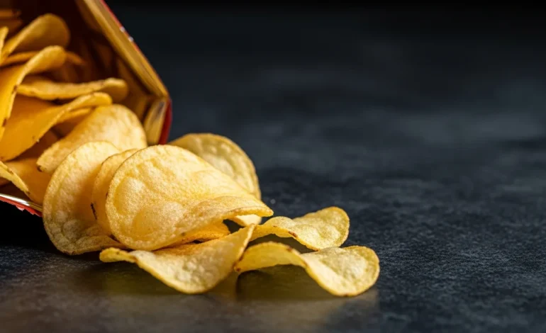 FDA Upgrades Recall of Utz Potato Chips Due to Salmonella Risk shown near a caution sign on a granite counter.
